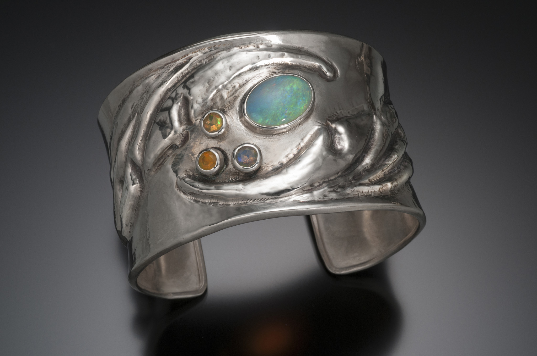 Chasing and repousse cuff bracelet with opals
